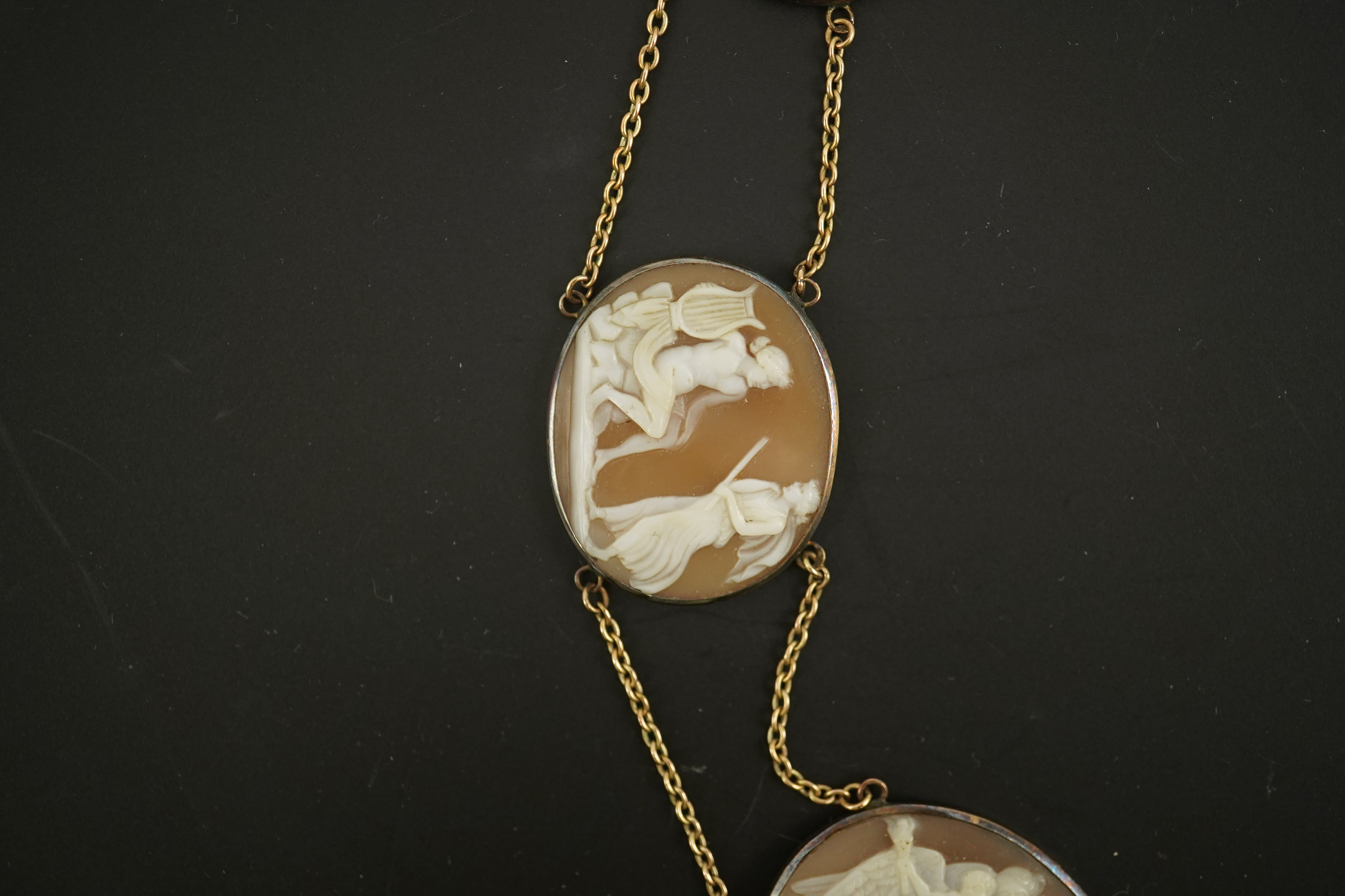 An early 19th century Italian Grand Tour gold double chain link and ten graduated oval cameo shell set necklace